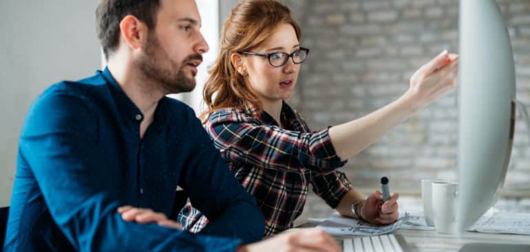 iExcel Custom Software Programmer working in a software developing company office